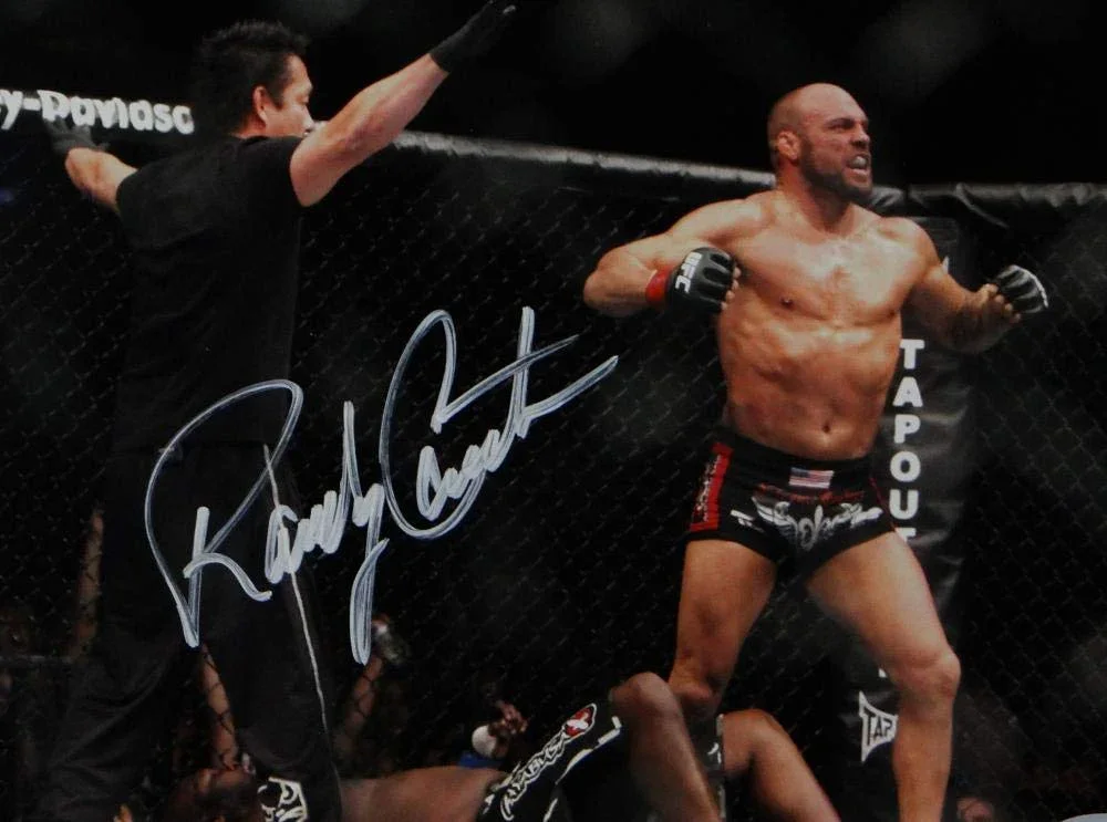 Randy Couture Autographed UFC 8x10 Photo Knock Out- Beckett Auth White Ref Facing Couture